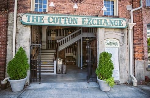 Red brick building with large sign at entrance that says The Cotton Exchange
